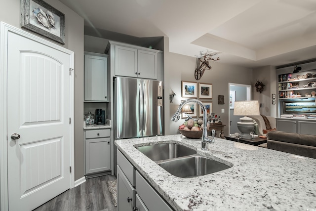 kitchen featuring a sink, dark wood-style flooring, gray cabinetry, freestanding refrigerator, and open floor plan