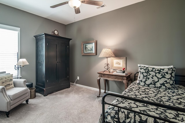 carpeted bedroom featuring visible vents, a ceiling fan, and baseboards