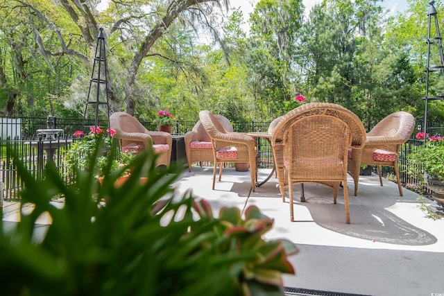 view of patio featuring fence and outdoor dining space