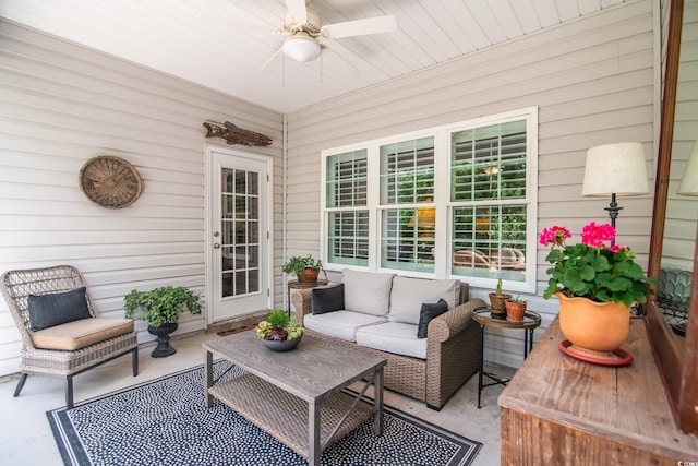 sunroom with ceiling fan and an outdoor living space