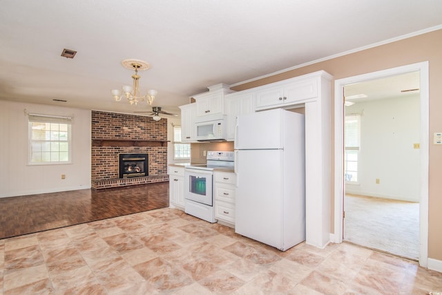 391 Waterford Dr, Georgetown, SC 29440 - kitchen featuring white appliances, a chandelier, healthy amount of natural light, white cabinets, and crown molding