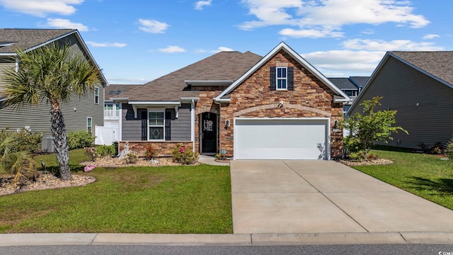 181 Ocean Commons Dr, Surfside Beach, SC 29575 - view of front of house with driveway, a front yard, stone siding, and a garage