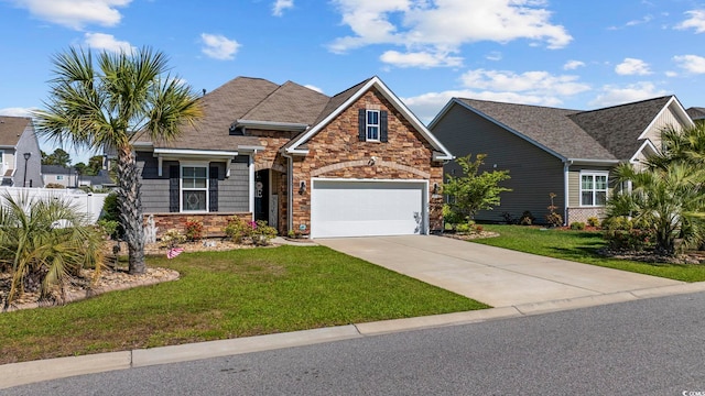 181 Ocean Commons Dr, Surfside Beach, SC 29575 - view of front of property featuring a garage, stone siding, fence, a front lawn, and driveway
