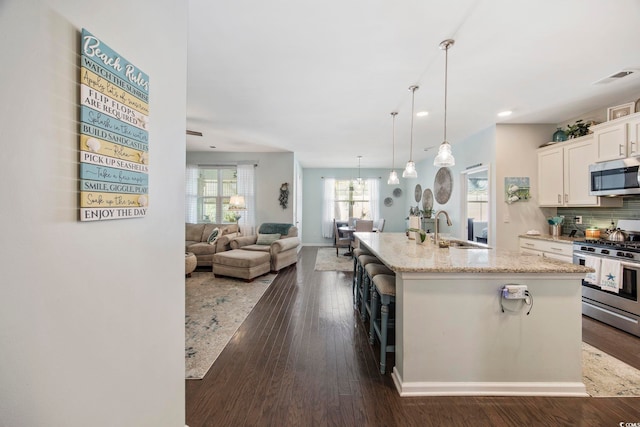 181 Ocean Commons Dr, Surfside Beach, SC 29575 - kitchen with white cabinets, light stone countertops, visible vents, appliances with stainless steel finishes, and a sink