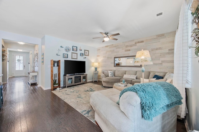 181 Ocean Commons Dr, Surfside Beach, SC 29575 - living area featuring visible vents, baseboards, an accent wall, ceiling fan, and dark wood finished floors
