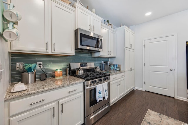 181 Ocean Commons Dr, Surfside Beach, SC 29575 - kitchen with backsplash, dark wood finished floors, white cabinetry, and stainless steel appliances