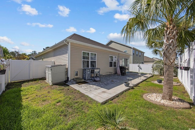 181 Ocean Commons Dr, Surfside Beach, SC 29575 - rear view of property featuring a yard, a fenced backyard, a gate, and a patio area