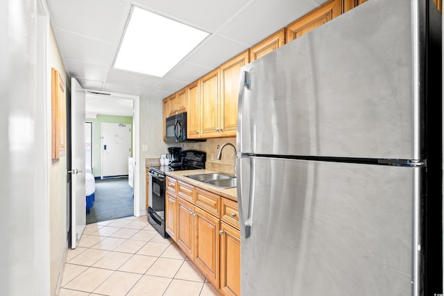 3000 N Ocean Blvd Unit 729, Myrtle Beach, SC 29577 - kitchen featuring black appliances, a sink, light tile patterned floors, and light countertops