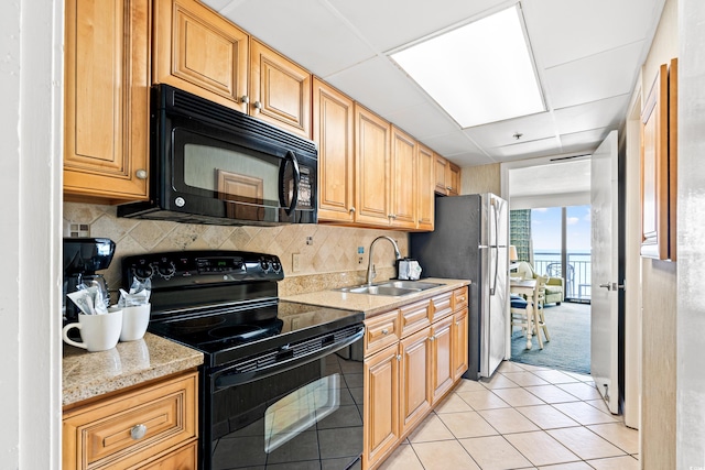 3000 N Ocean Blvd Unit 729, Myrtle Beach, SC 29577 - kitchen featuring black appliances, a sink, a drop ceiling, backsplash, and light tile patterned flooring