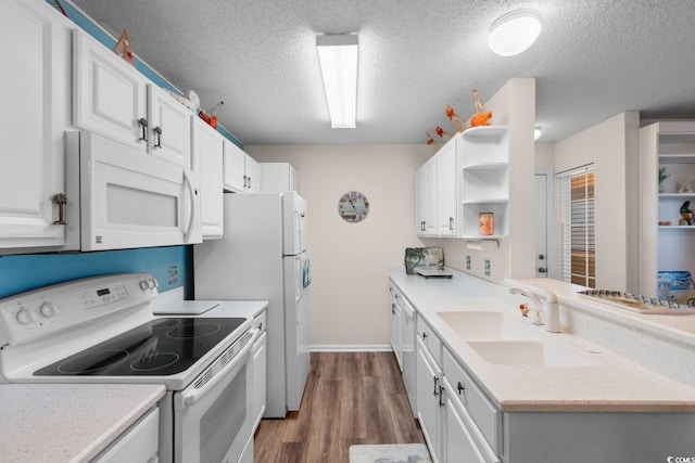 kitchen featuring open shelves, white cabinetry, a sink, and white appliances