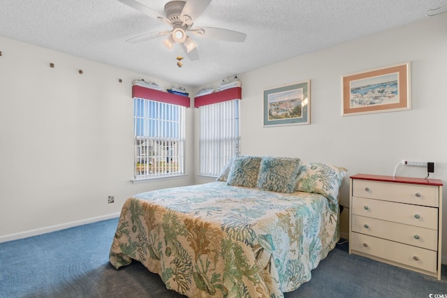bedroom featuring a ceiling fan, baseboards, carpet floors, and a textured ceiling