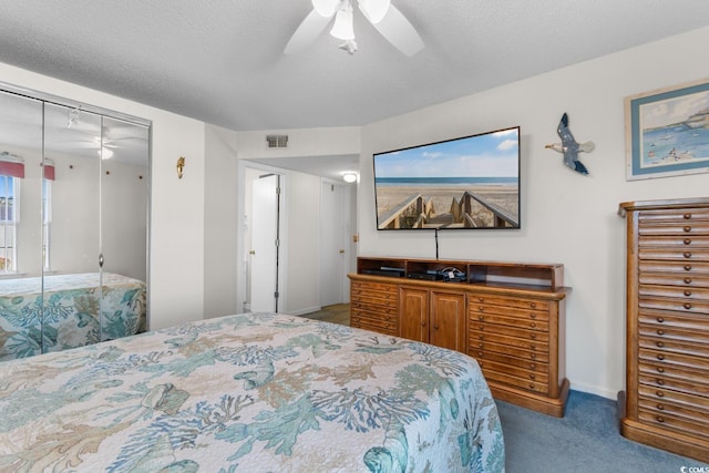 bedroom with visible vents, a closet, baseboards, carpet flooring, and ceiling fan
