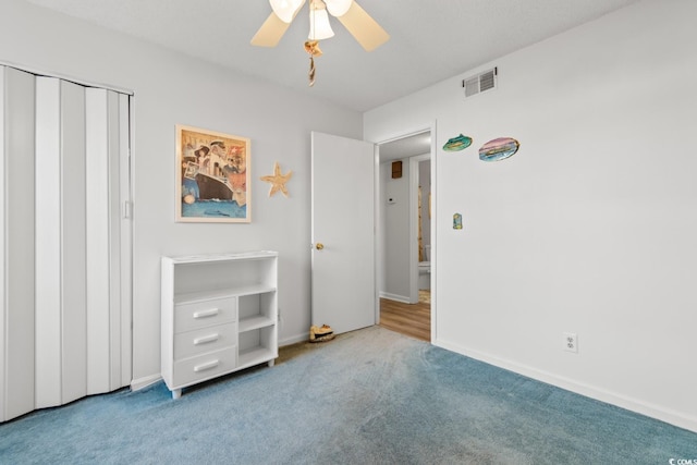 unfurnished bedroom featuring a closet, ceiling fan, baseboards, carpet flooring, and visible vents