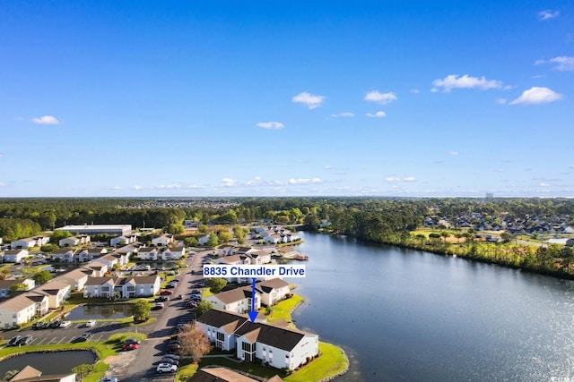 drone / aerial view with a residential view and a water view