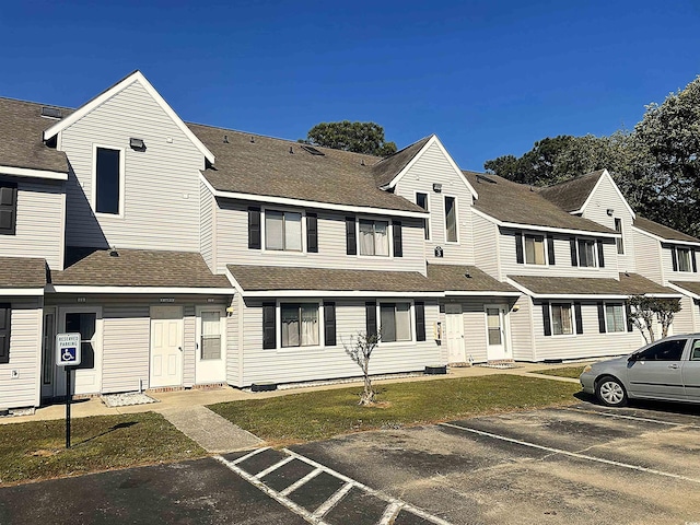 500 Fairway Village Dr Unit 3I, Myrtle Beach, SC 29588 - view of front of property featuring uncovered parking, a front lawn, and a shingled roof