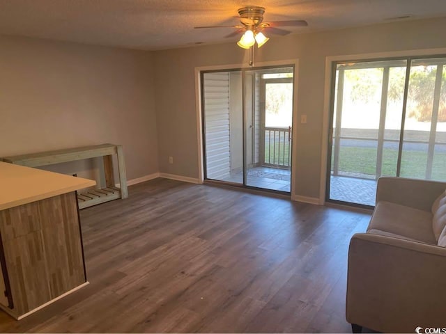 500 Fairway Village Dr Unit 3I, Myrtle Beach, SC 29588 - living area featuring baseboards, a ceiling fan, and dark wood-style floors
