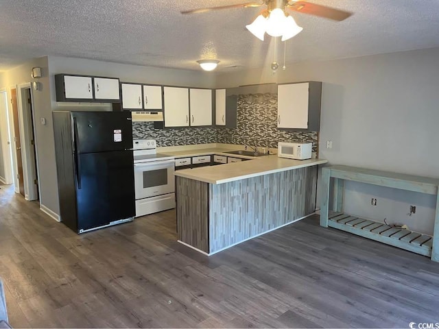 500 Fairway Village Dr Unit 3I, Myrtle Beach, SC 29588 - kitchen featuring white appliances, under cabinet range hood, a sink, a peninsula, and backsplash
