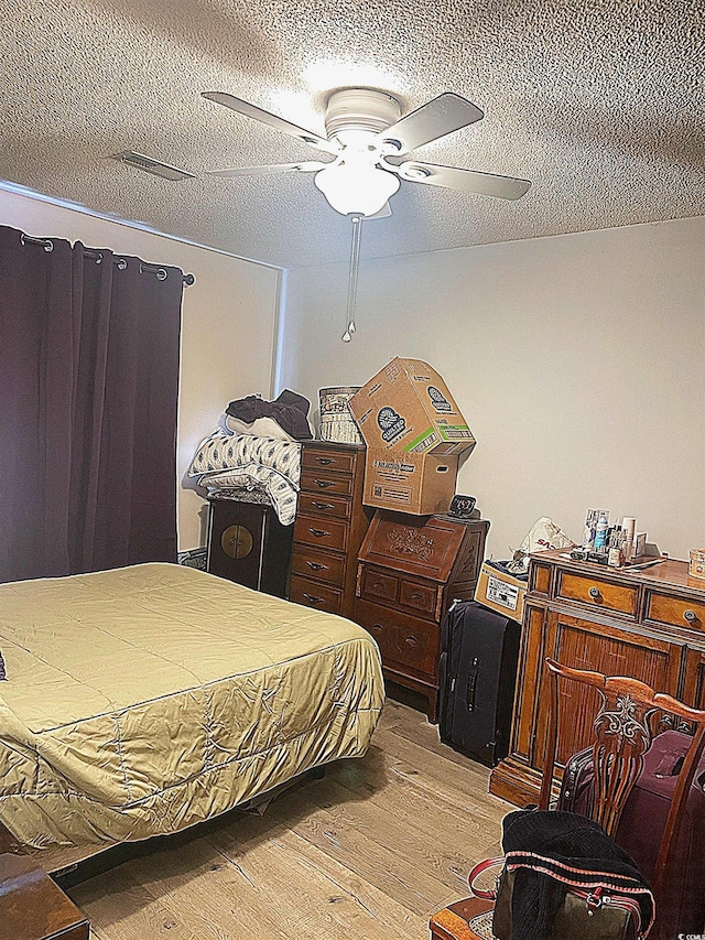 500 Fairway Village Dr Unit 3I, Myrtle Beach, SC 29588 - bedroom featuring light wood-type flooring, a textured ceiling, and a ceiling fan
