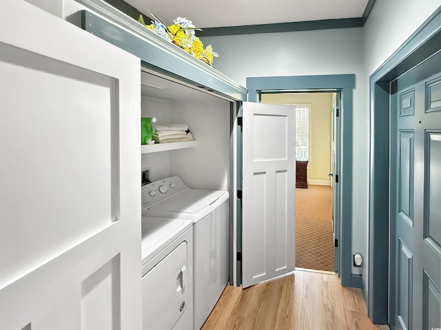 147 Brown Pelican Loop, Pawleys Island, SC 29585 - laundry area with washing machine and dryer, light wood finished floors, and light carpet
