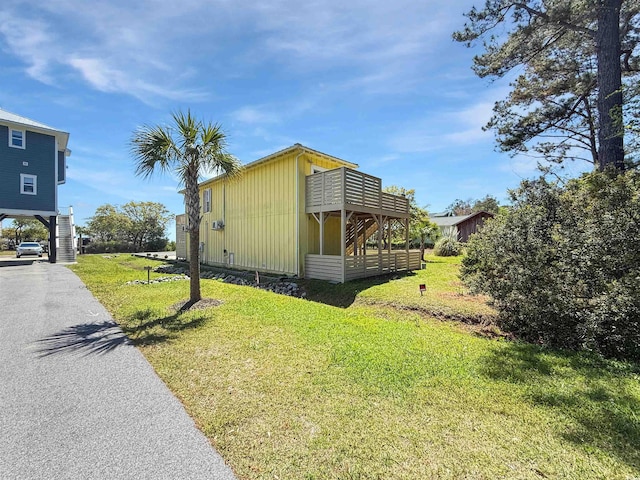 147 Brown Pelican Loop, Pawleys Island, SC 29585 - view of side of home with stairway, a lawn, and board and batten siding