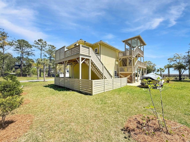 147 Brown Pelican Loop, Pawleys Island, SC 29585 - back of house featuring stairs, a lawn, and a wooden deck
