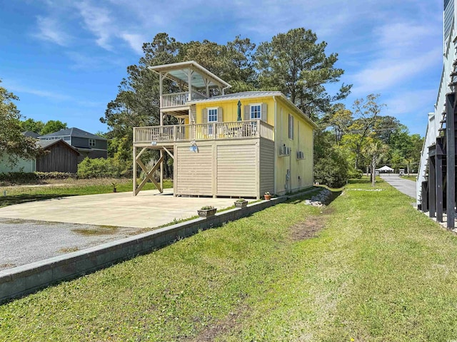 147 Brown Pelican Loop, Pawleys Island, SC 29585 - back of house featuring driveway, a lawn, a patio, a wooden deck, and a balcony