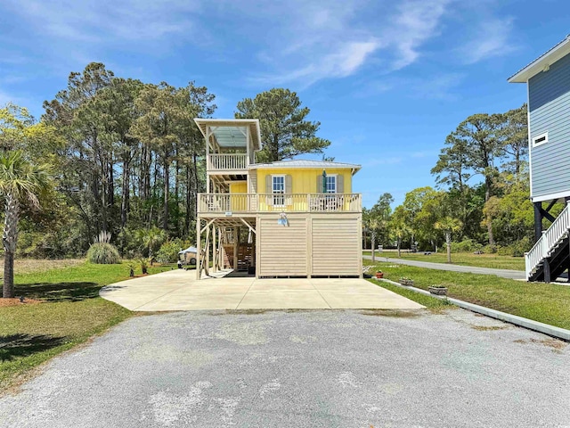 147 Brown Pelican Loop, Pawleys Island, SC 29585 - view of front of property featuring stairs and a front lawn