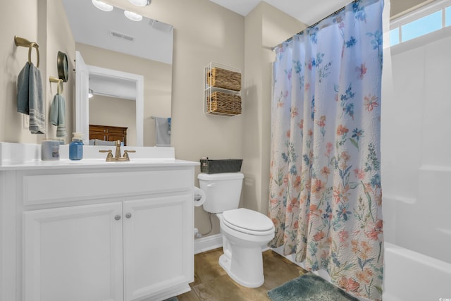 bathroom featuring visible vents, vanity, toilet, baseboards, and shower / tub combo