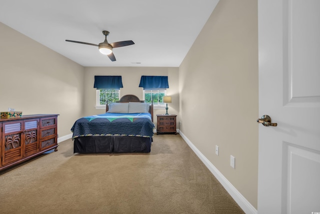 carpeted bedroom featuring baseboards and a ceiling fan