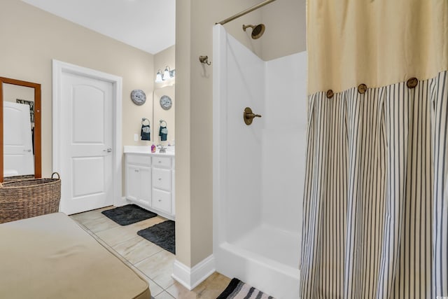 bathroom featuring walk in shower, tile patterned flooring, and vanity