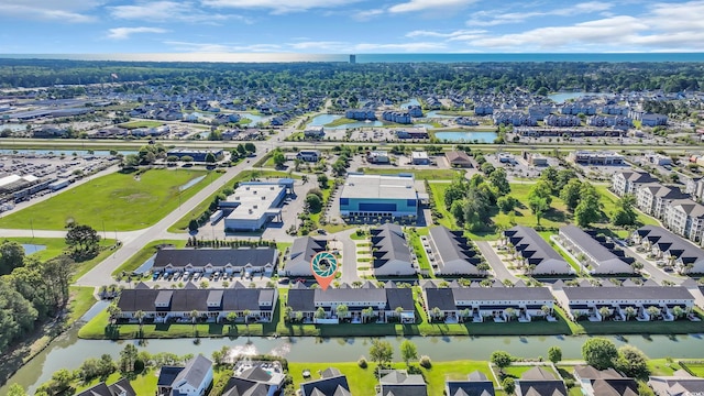 drone / aerial view with a water view and a residential view