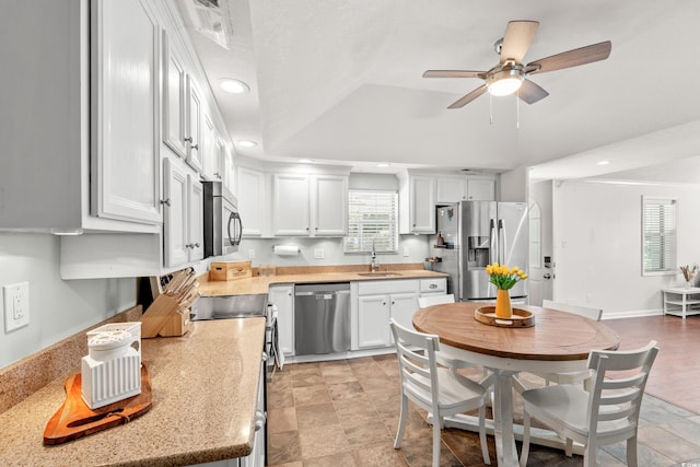 kitchen with a ceiling fan, recessed lighting, white cabinets, a sink, and stainless steel appliances