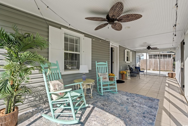 view of patio / terrace with ceiling fan and fence