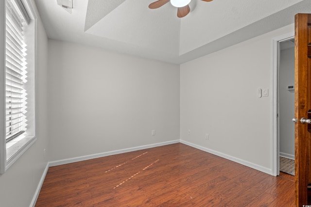unfurnished room featuring baseboards, ceiling fan, and wood finished floors