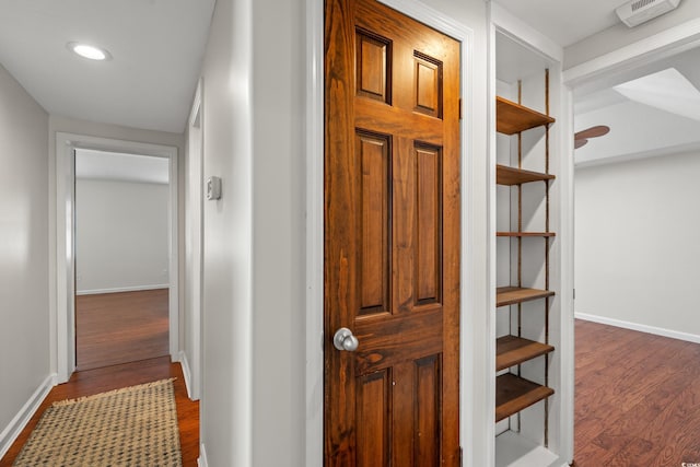 hallway with recessed lighting, baseboards, and dark wood-style floors