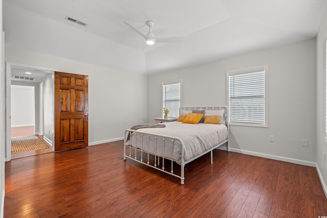 bedroom with baseboards, wood finished floors, and visible vents