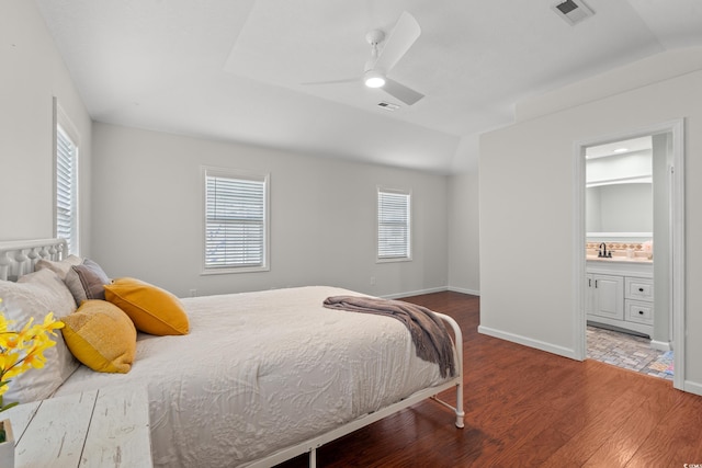 bedroom featuring visible vents, multiple windows, and wood finished floors