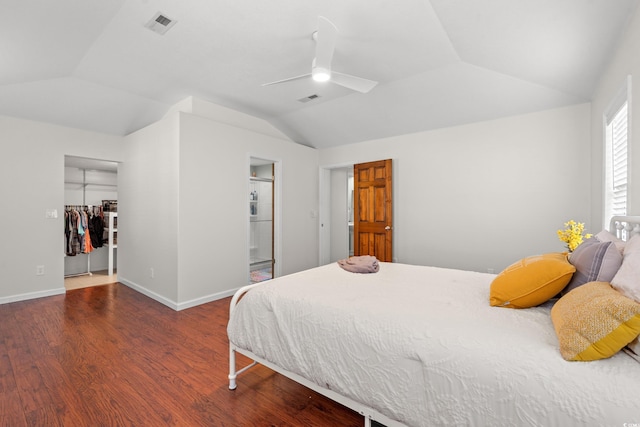 bedroom with visible vents, a ceiling fan, wood finished floors, and vaulted ceiling