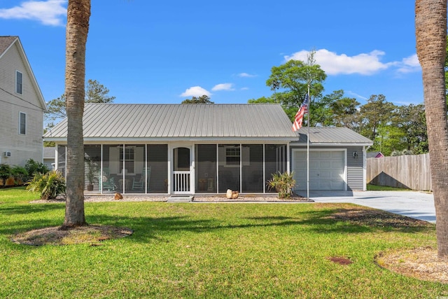 view of front of property with a sunroom, a garage, fence, and concrete driveway