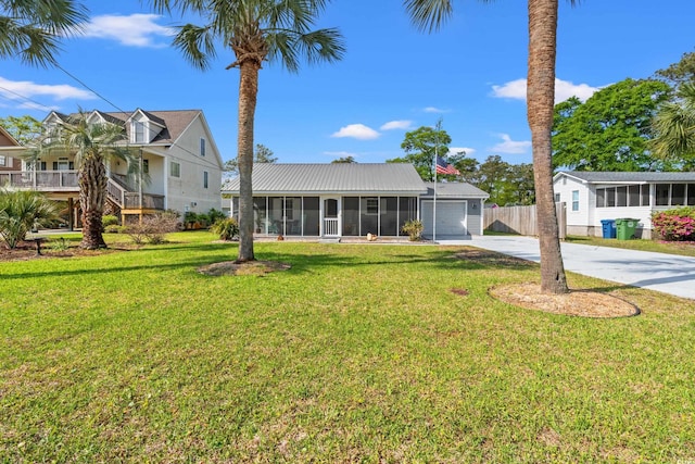 view of front of property featuring fence, an attached garage, a front lawn, a sunroom, and concrete driveway