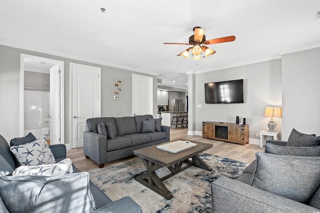304 S Hillside Dr Unit B, North Myrtle Beach, SC 29582 - living area featuring crown molding, ceiling fan, light wood-type flooring, and baseboards