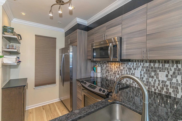 4560 Greenbriar Dr Unit 306B, Little River, SC 29566 - kitchen featuring appliances with stainless steel finishes, tasteful backsplash, ornamental molding, dark stone countertops, and light wood finished floors