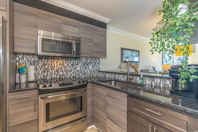 4560 Greenbriar Dr Unit 306B, Little River, SC 29566 - kitchen with stainless steel appliances, a sink, backsplash, ornamental molding, and dark stone counters