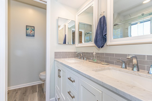 4560 Greenbriar Dr Unit 306B, Little River, SC 29566 - full bathroom featuring toilet, double vanity, decorative backsplash, wood finished floors, and baseboards
