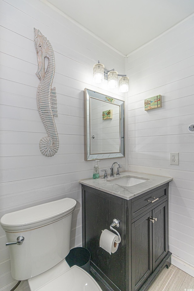 4560 Greenbriar Dr Unit 306B, Little River, SC 29566 - bathroom with toilet, vanity, and wood walls