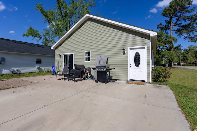 rear view of property featuring a patio area