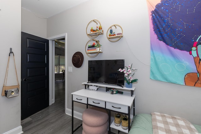 interior space featuring baseboards and wood finished floors