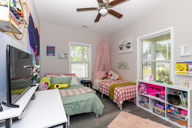 bedroom featuring ceiling fan, visible vents, and wood finished floors