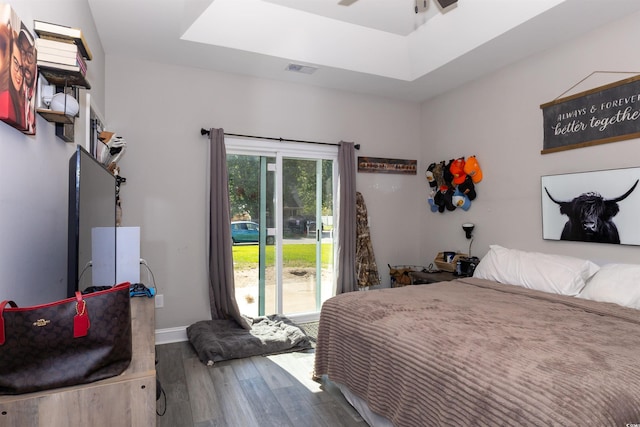 bedroom featuring visible vents, baseboards, wood finished floors, and a skylight