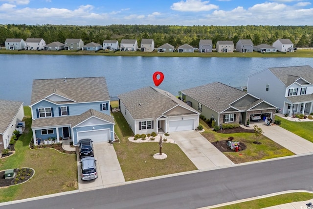 birds eye view of property with a residential view and a water view